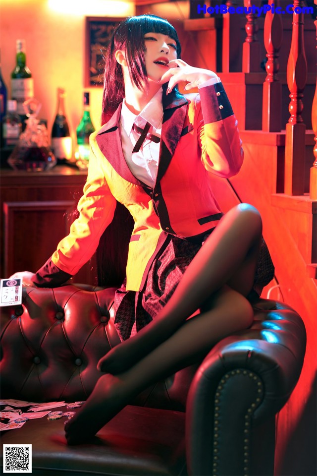 A woman sitting on a couch smoking a cigarette.